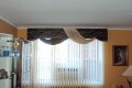 Cornice with attached swags over Fabric Verticals